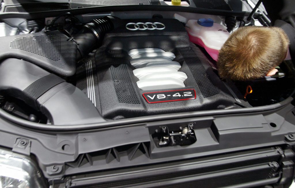 Audi's 4.2-liter V8 is examined by a spectator at an auto show