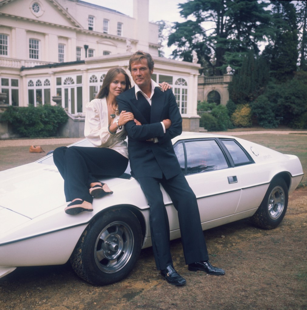1977: Barbara Bach and Roger Moore, stars of the James Bond film 'The Spy Who Loved Me' leaning on the now-famous 'amphibious' Lotus Esprit. (Photo by Hulton Archive/Getty Images). This is a classic sports car both James Bond and Jay Leno love.