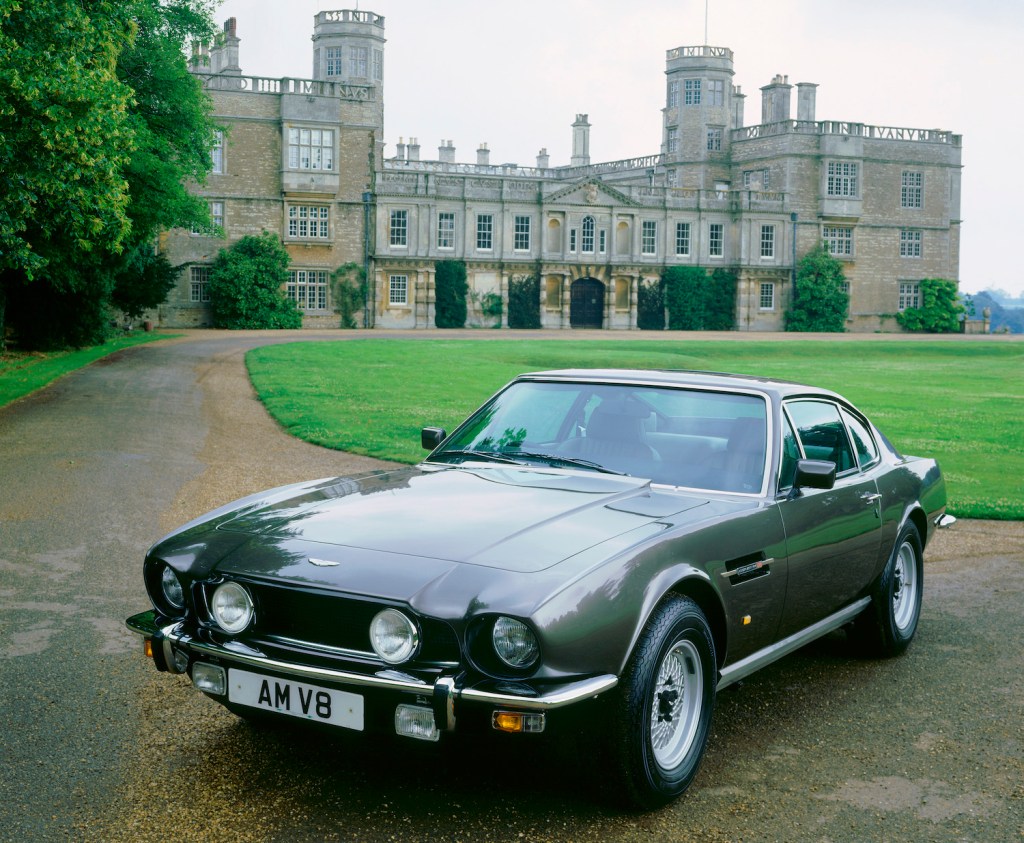 This is a gray 1987 Aston Martin V8 Coupe in front of a mansion. An identical car was one of James Bond's Classic cars (Photo by National Motor Museum/Heritage Images/Getty Images)