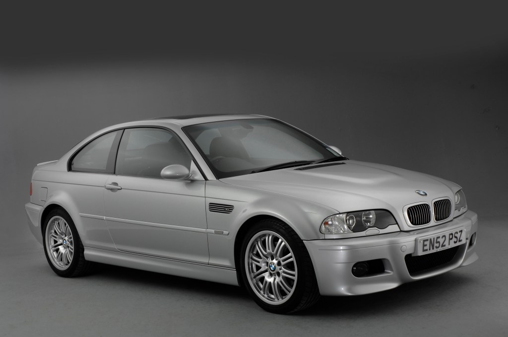 A Silbergrau metallic BMW M3 E46 in a studio booth, photographed from the front 3/4