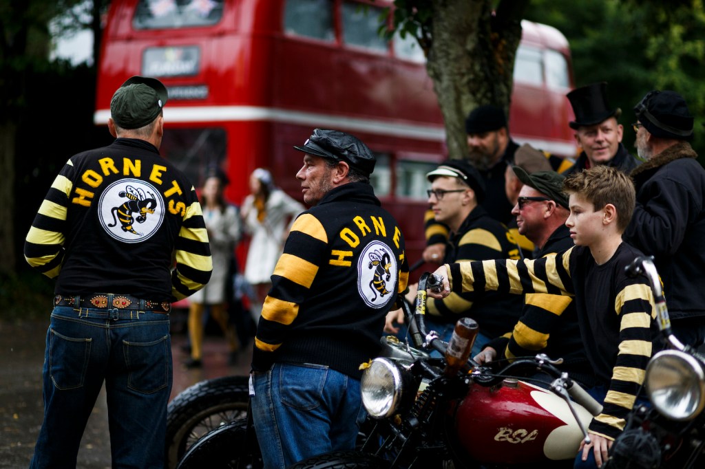 CHICHESTER, ENGLAND - SEPTEMBER 09:  A group of men dressed in vintage biker clothes attend the Goodwood Revival at Goodwood on September 10, 2016 in Chichester, England.  (Photo by Tristan Fewings/Getty Images) find out the Goodwood Revival schedule and whether you have to dress up for the Goodwood Revival.