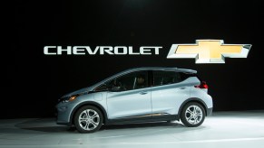 The Chevrolet Bolt drives onstage during a press conference at the 2017 North American International Auto Show in Detroit. Chris Pratt drives a 2017 Chevy Bolt in The Tomorrow War as part of GM's Ultium product placement | GEOFF ROBINS/AFP via Getty Images