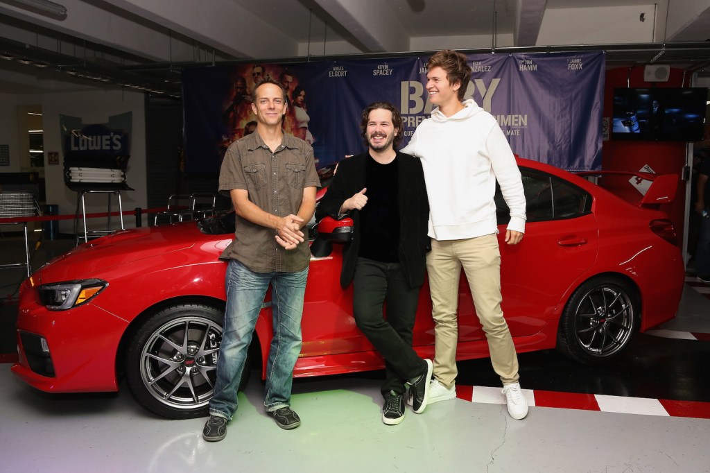 Stuntman Jeremy Fry, film director Edgar Wright and actor Ansel Elgort in front of one of the cars in baby driver: a 2006 Subaru Impreza WRX. (Photo by Victor Chavez/Getty Images)