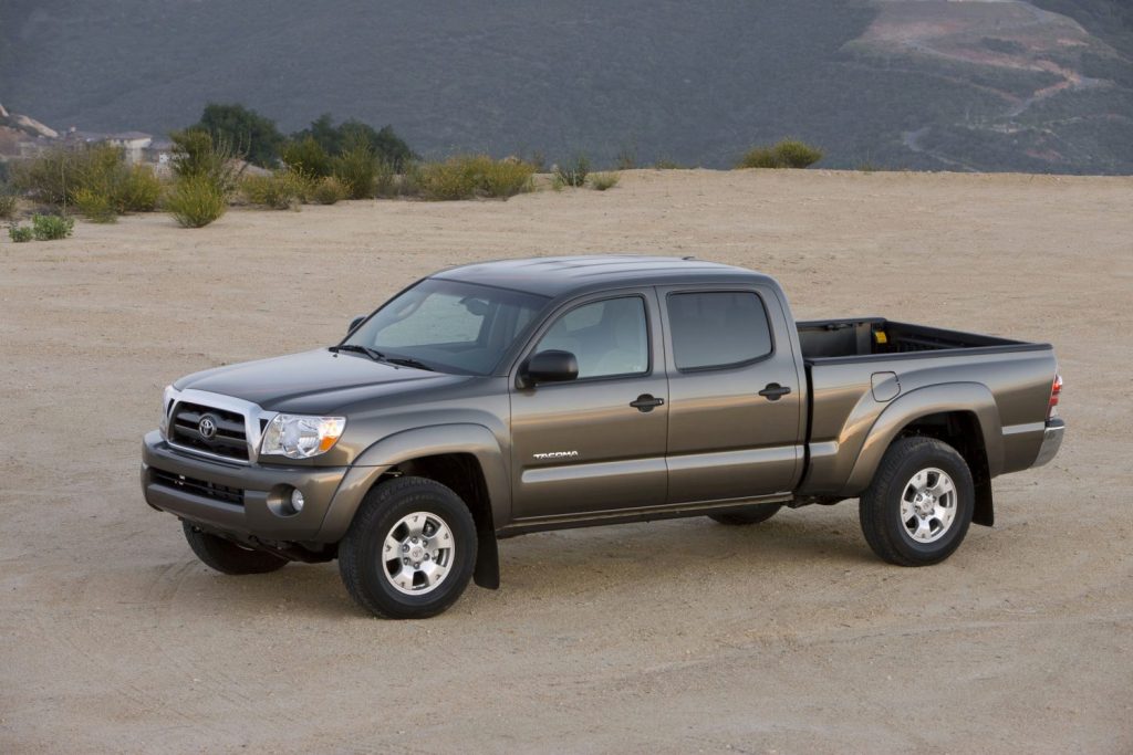 Gray 2009 Toyota Tacoma with mountains in the background