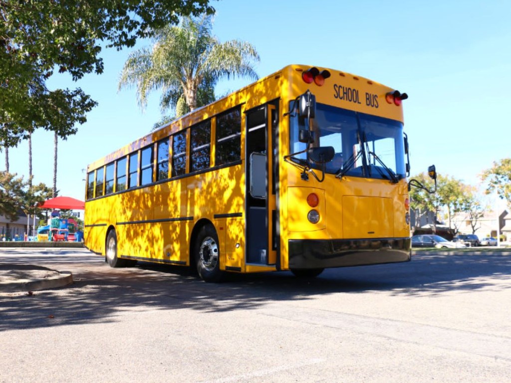 GreenPower BEAST school bus driving in a parking lot