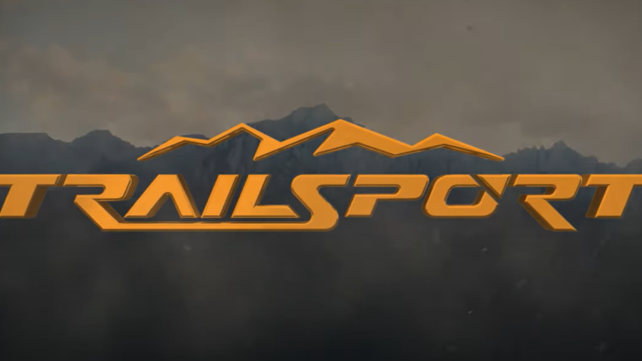 Orange Honda Trailsport logo with mountains in the background