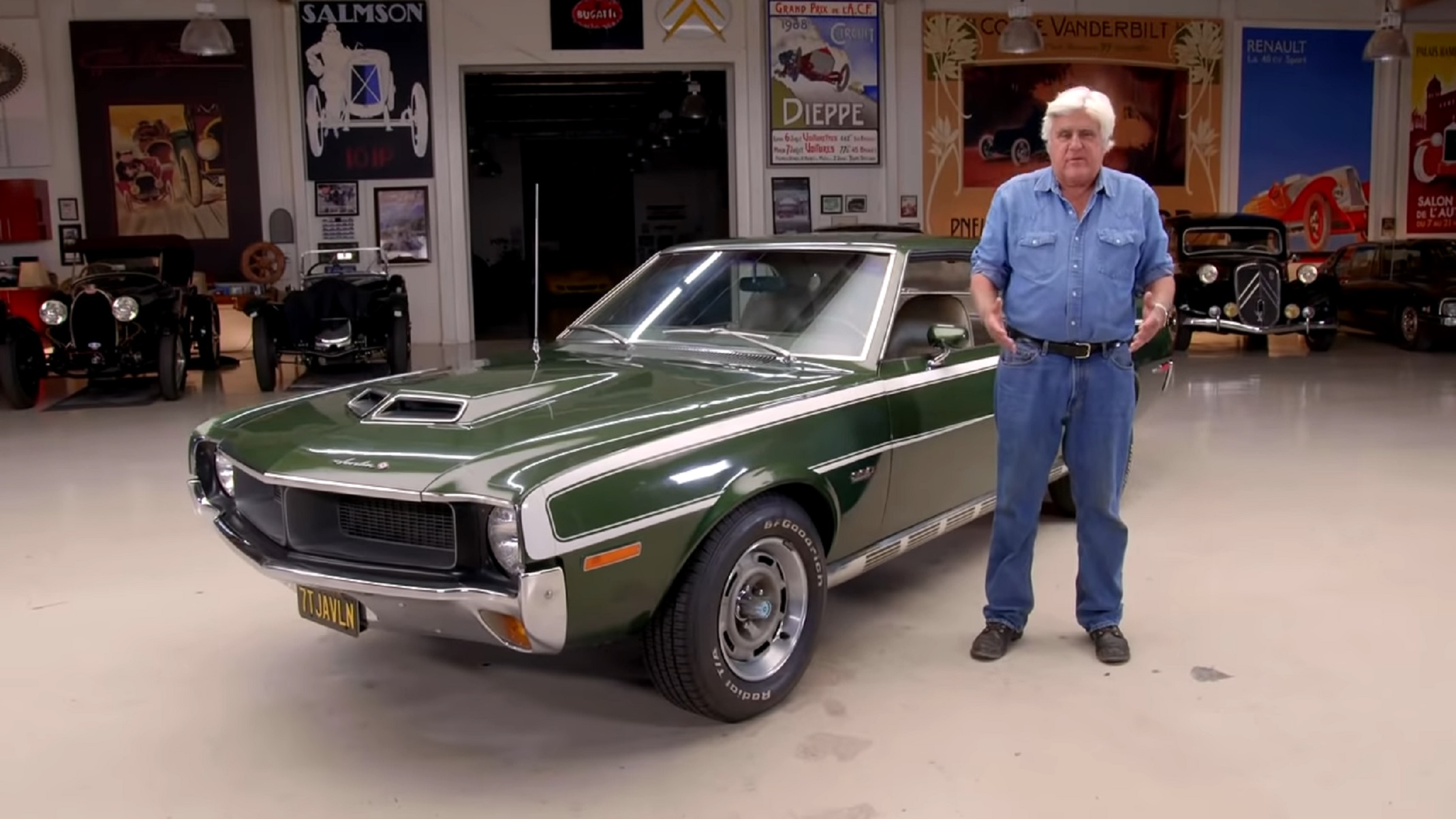Jay Leno with a green-and-white 1970 AMC Javelin Mark Donohue Special in his garage