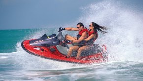 A young couple rides a Kawasaki Jet Ski personal watercraft near Islamorada in the Florida Keys