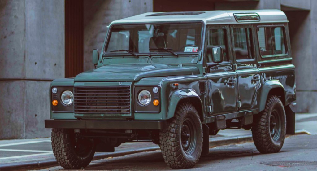A custom-built Land Rover Defender 110 by Brooklyn Coachworks is parked. The vehicle was restored and modified by Brooklyn Coachworks.