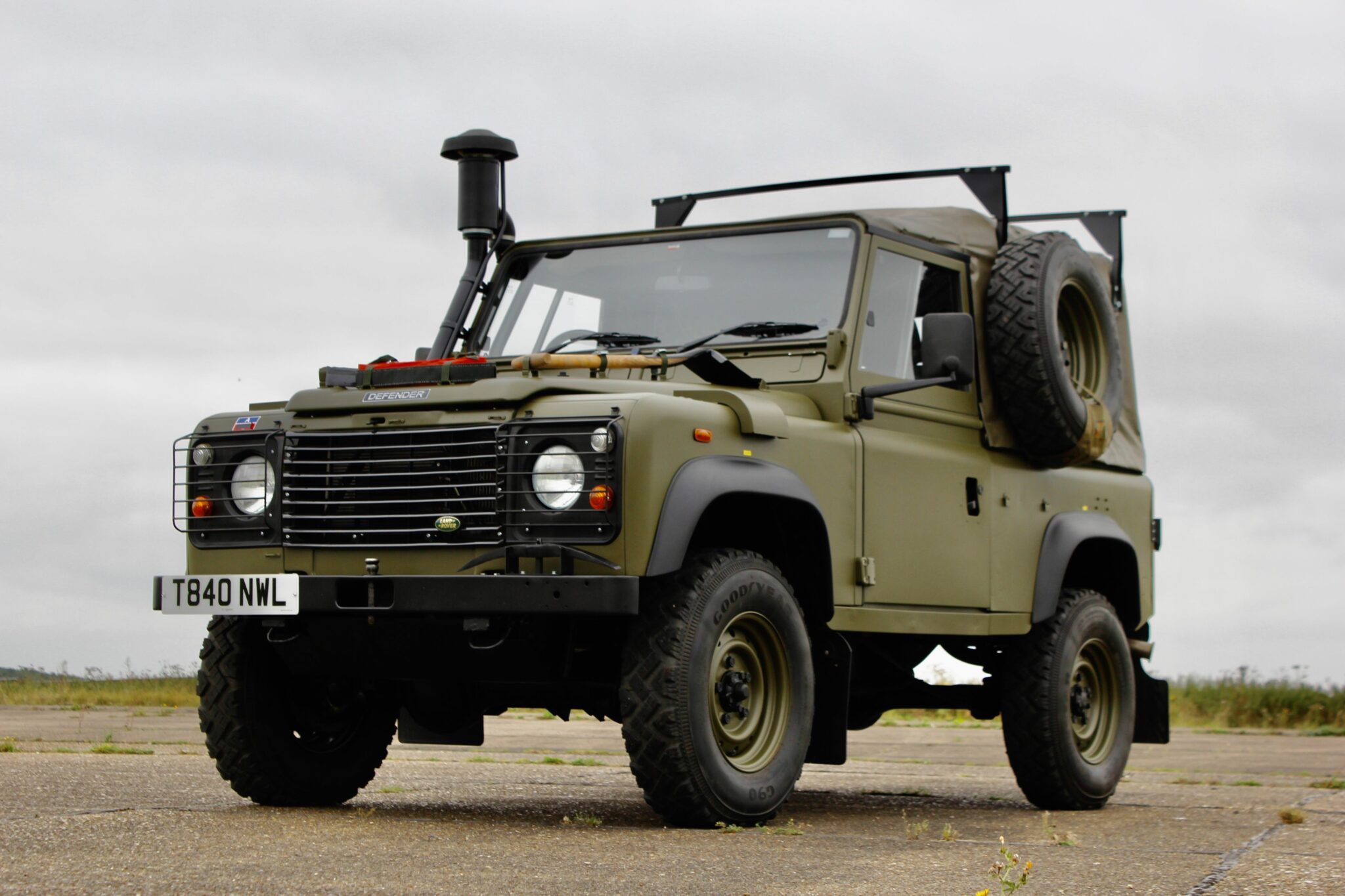 One of very few Land Rover Defender Winter Water Wolf parked in the gravel is one of the coolest vintage 4x4 SUVs ever made is for sale