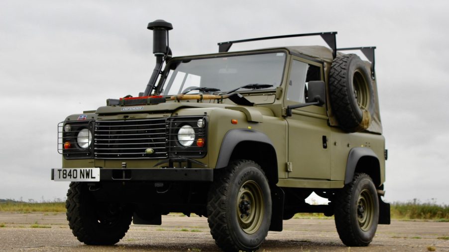 One of very few Land Rover Defender Winter Water Wolf parked in the gravel is one of the coolest vintage 4x4 SUVs ever made is for sale