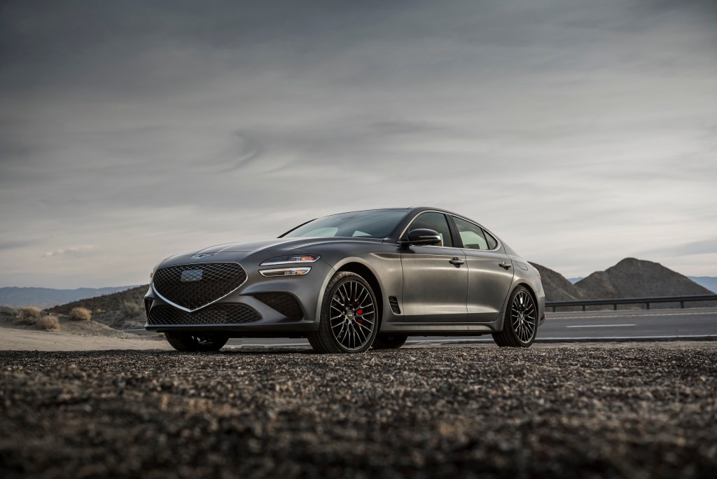 A grey Genesis G70 in the desert