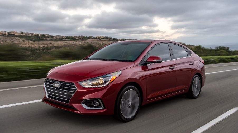 A red 2022 Hyundai Accent on the road on an overcast day