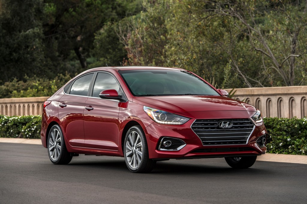 A red 2022 Hyundai Accent sits on the street during the golden hour