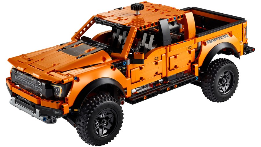 Lego Technic Ford F-150 Raptor set seen in "Code Orange" color and knob attachment at top to allow turning the front wheels.