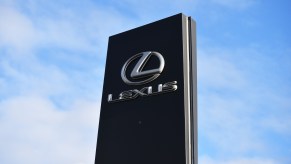 The Lexus logo on a car dealership sign