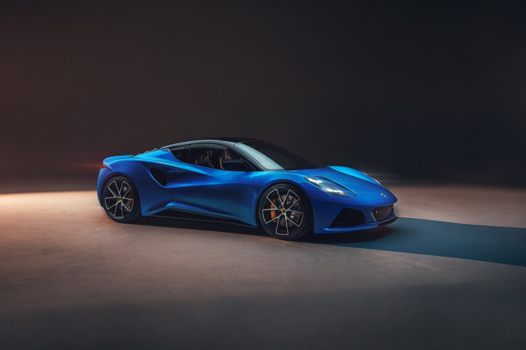 A blue Lotus Emira sports car shot in a studio in profile