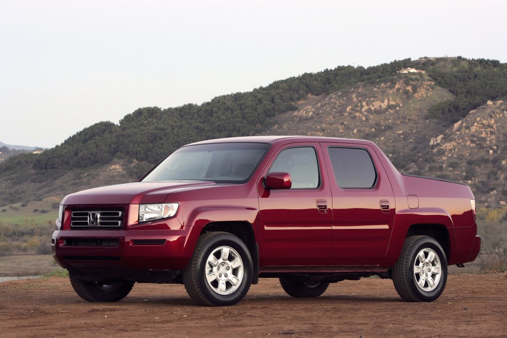 Maroon 2006 Honda Ridgeline with mountains in the background
