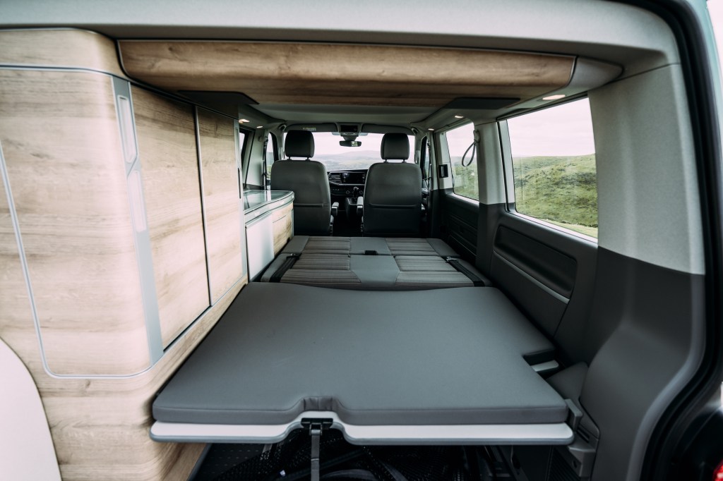 Volkswagen California camper van interior with the bed laid out.