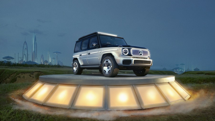 The black-and-silver Mercedes-Benz Concept EQG on a plinth in a field