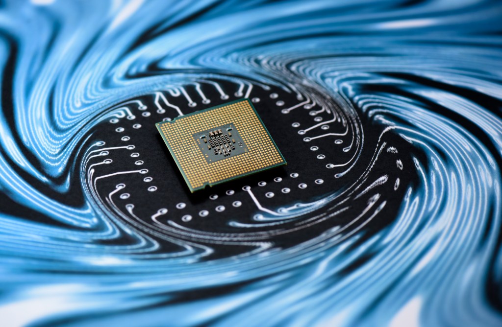 A microchip sitting on a swirling background