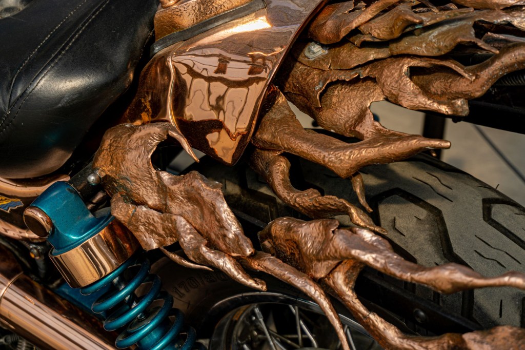 The close-up view of the hand-beaten copper flames at the rear of Mike Prete's custom 1998 Suzuki Intruder