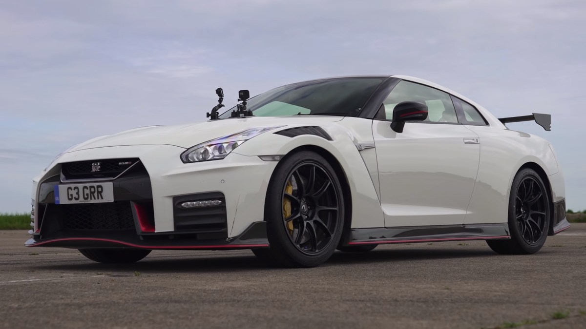 A white Nissan GT-R NISMO with GoPro cameras attached to its hood as it waits to drag race