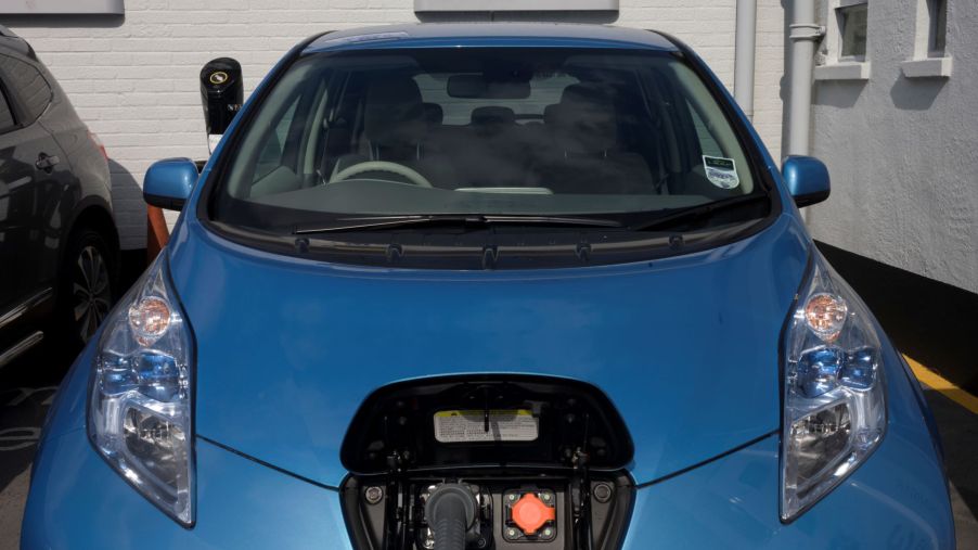 A Nissan Leaf charging in a parking garage at a South London dealership