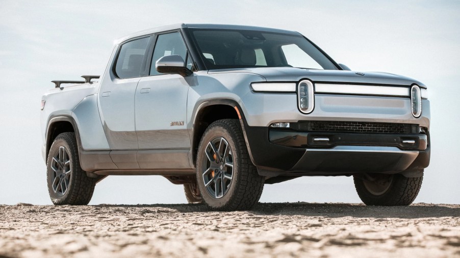 Passenger's side front angle view of gray Rivian R1T electric pickup truck