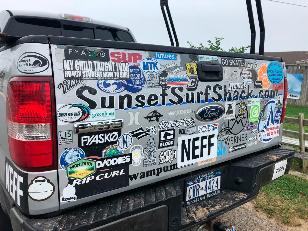 Pickup truck with many bumper stickers