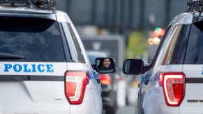 Two police vehicles parked side by side in a city