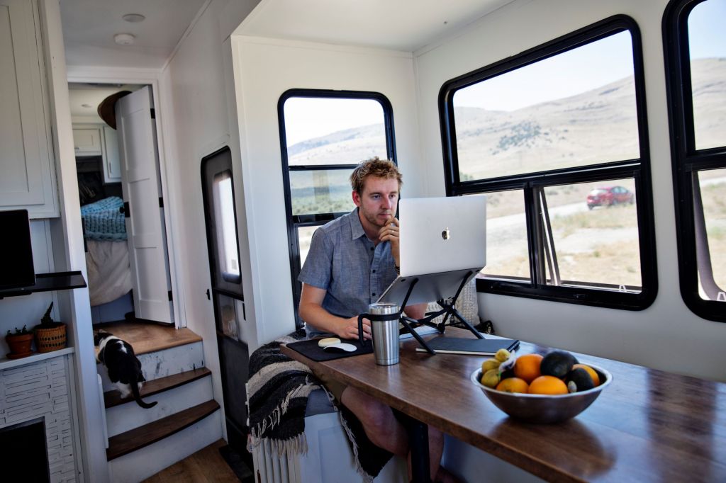 Programmer Kevin Holesh working on his computer using his RV internet