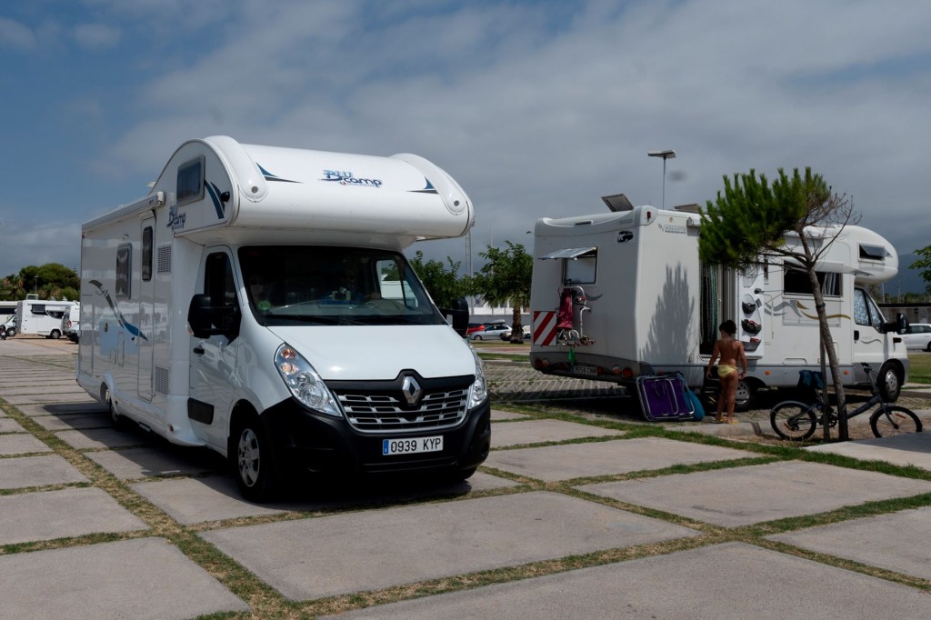 Two RVs parked on a concrete pad.