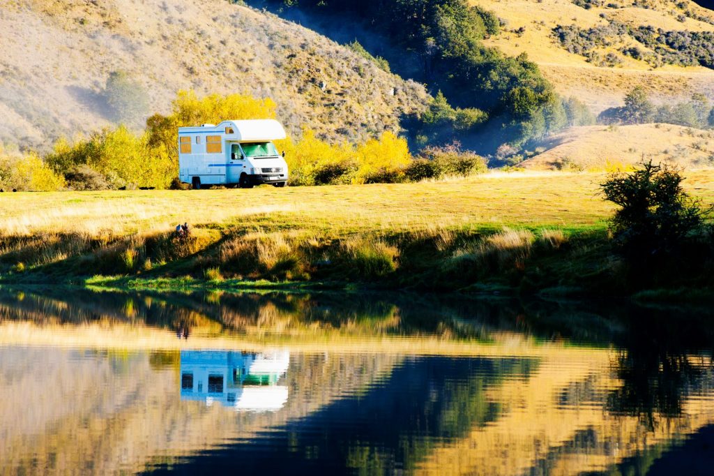 An RV camper parked in at the Lake Moke campsite during fall in Queenstown, South Island, New Zealand