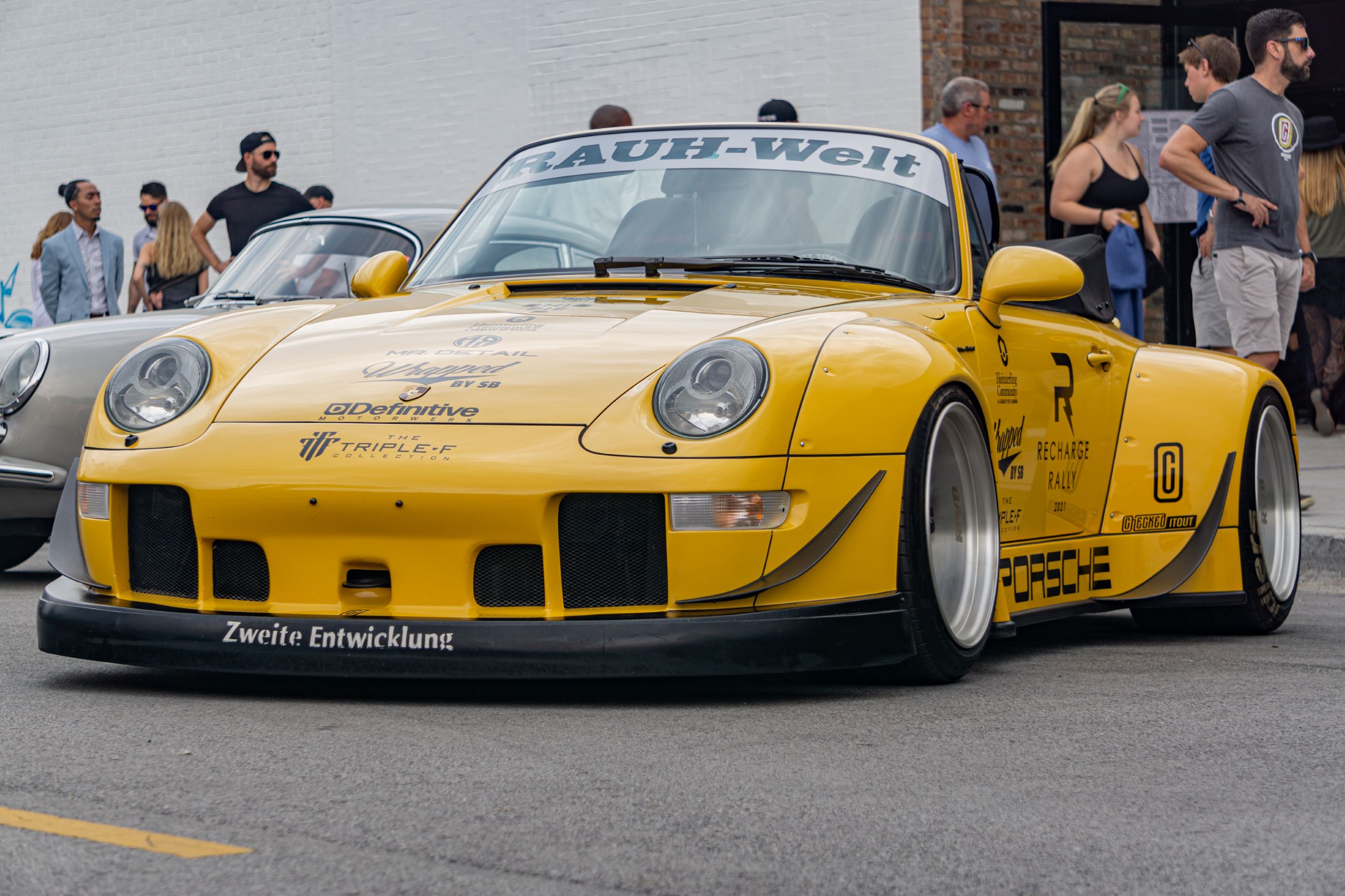 The front 3/4 view of the yellow-and-black RWB Porsche 993 911 Cabriolet 'Nohra'