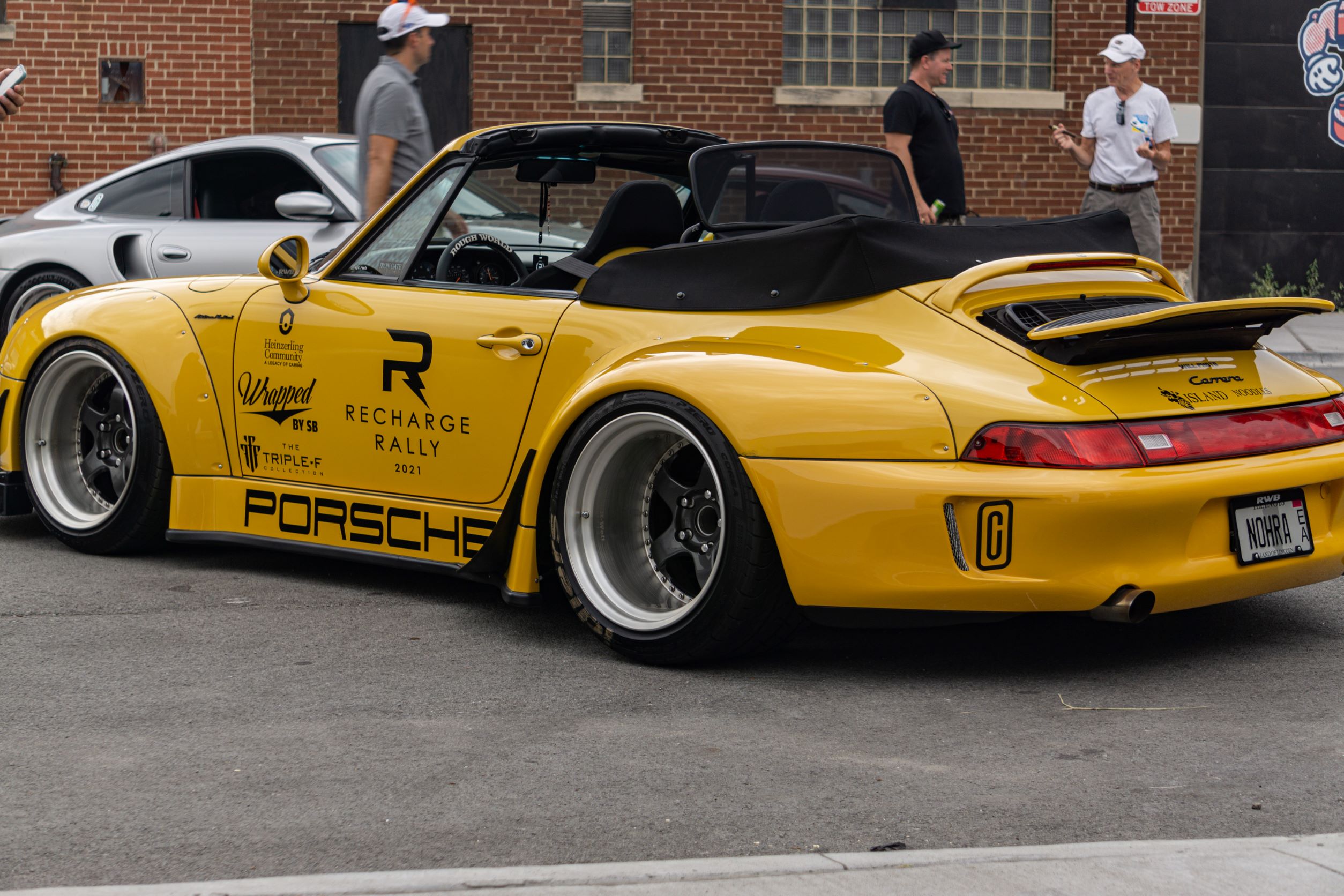 The side 3/4 view of the yellow-and-black RWB Porsche 993 911 Cabriolet 'Nohra'
