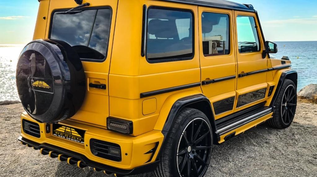 Rear view of yellow and black Mercedes-Benz G-Class G-Boss parked in front of a lake