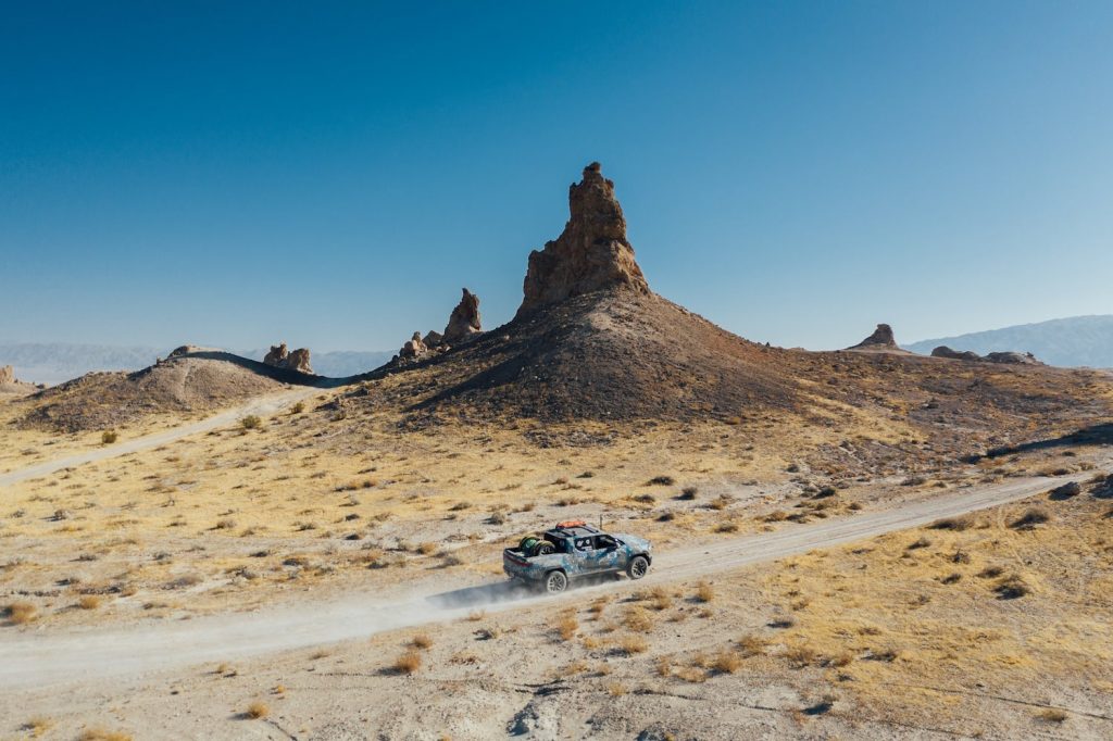 This is a press photo of the Quad-Motor Rivian Truck that Will Leave $100K EVs Far Behind. This is during an off-road rally.
