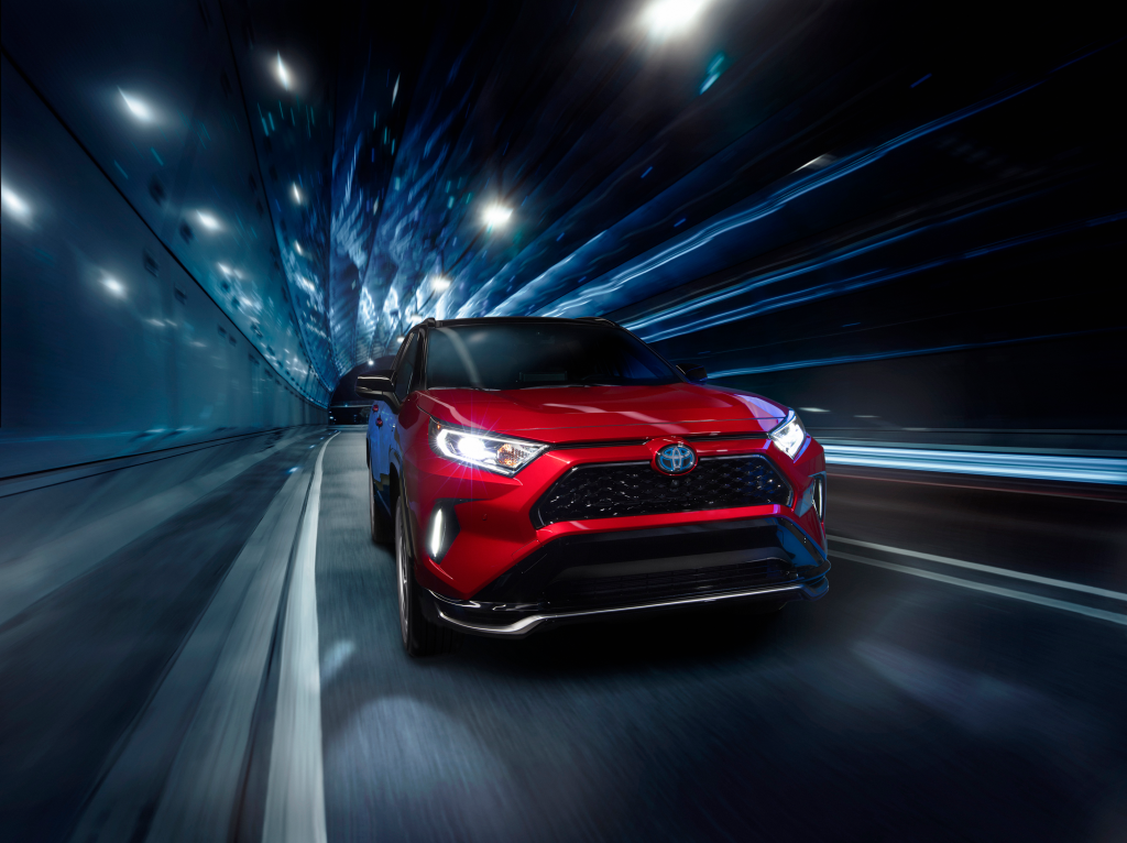Red 2021 Toyota RAV4 Prime driving through a tunnel