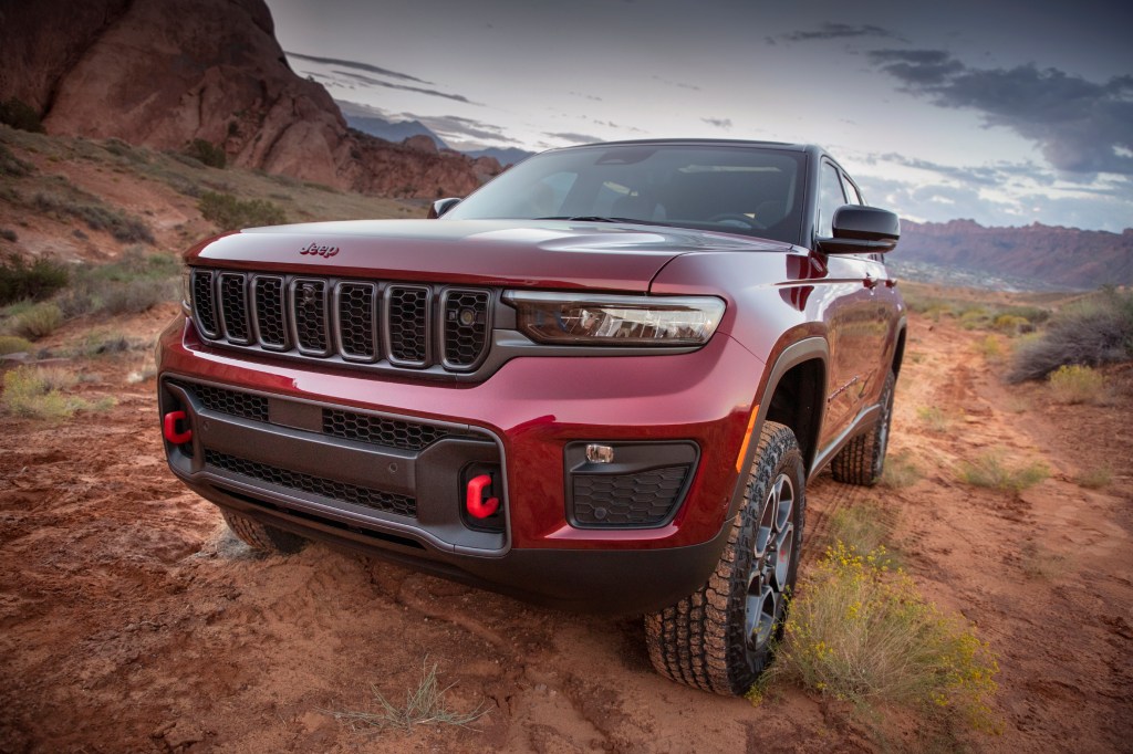 Red 2022 Jeep Grand Cherokee parked on a muddy trail