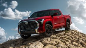 Red 2022 Toyota Tundra parked downward on a slope of a rock pile