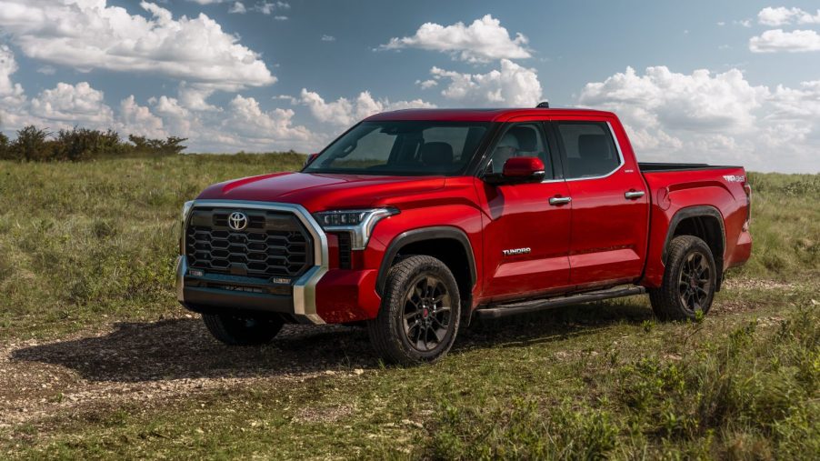 Red 2022 Toyota Tundra parked in a grassy field