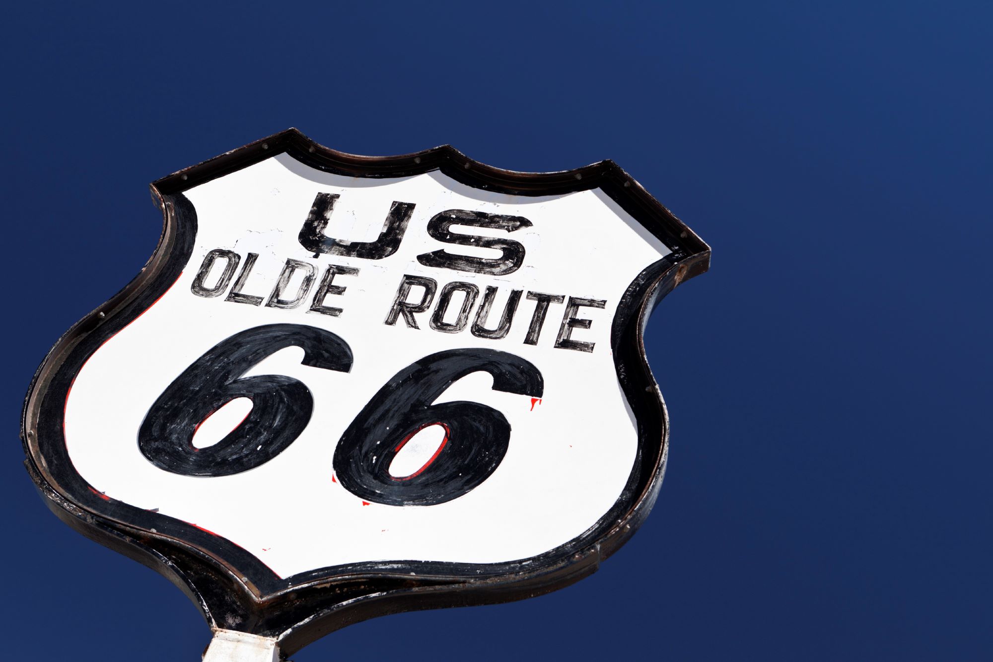 Route 66 sign in against a blue sky.
