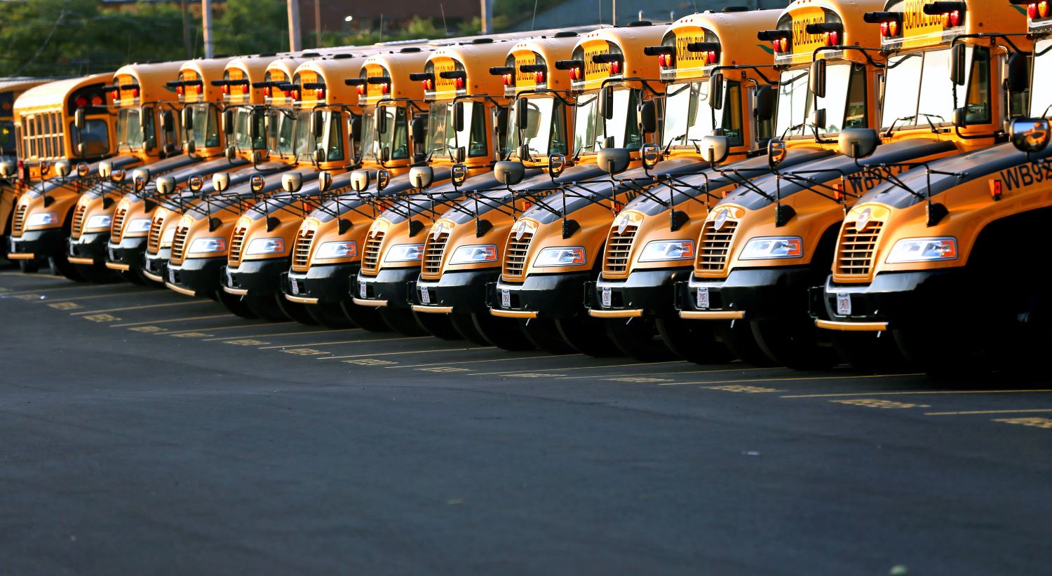 Row of school buses in a parking lot David L. Ryan The Boston Globe via Getty Images