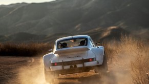 The rear view of a white Russell Built Fabrications Baja 911 sliding in the desert