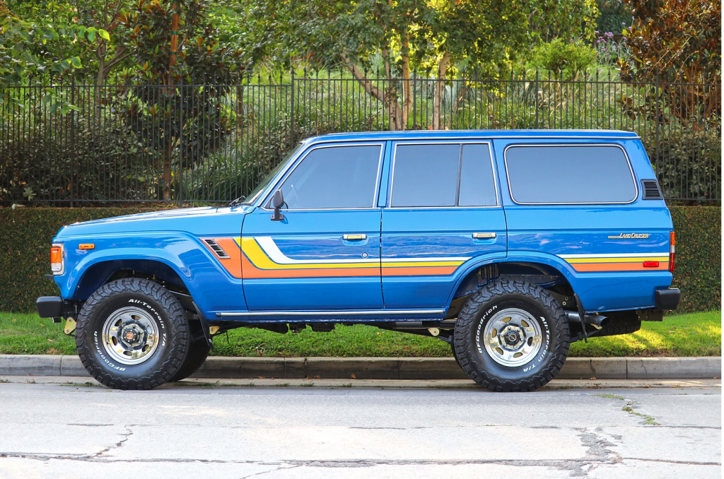 Profile view of Land Cuiser with paint and orange, yellow, and while stripes
