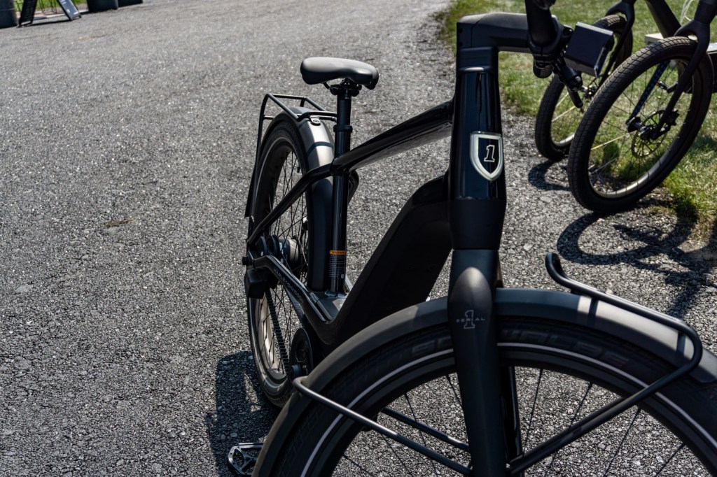 The front 3/4 view of a black Serial 1 RUSH/CTY Speed ebike on an asphalt path