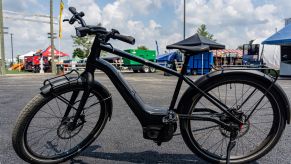 The side view of a black Serial 1 RUSH/CTY SPEED ebike in a parking lot