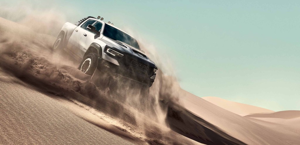 Silver 2022 Ram 1500 TRX driving down a sand dune