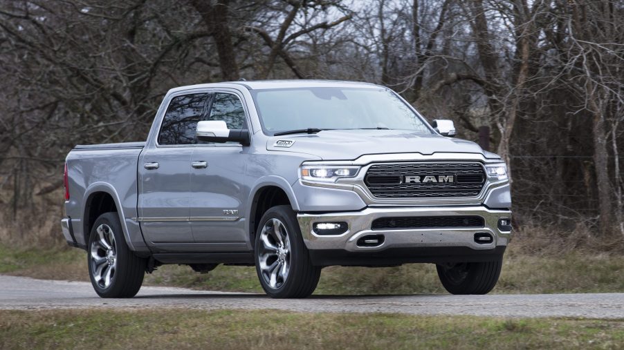 Silver 2022 Ram 1500 driving by a forest